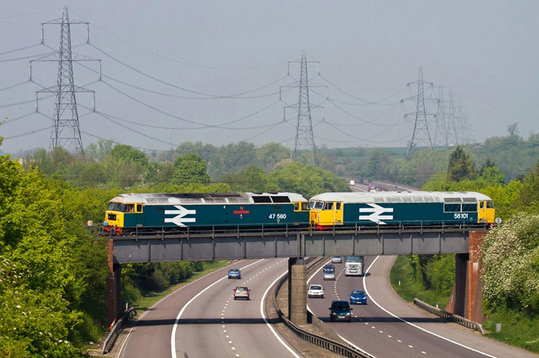 47580 crosses the A1(M) Baldock towing 56101 on 0Z56 1030 Dereham - Barrow Hill on 20/04/11, Photo by Colin Makcrow