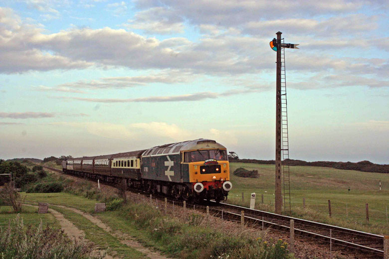 47580 passes Sheringham Golf Course with 1Z72 06:05 Holt - Scarborough on 09/07/11, Photo by Geoff Tibble
